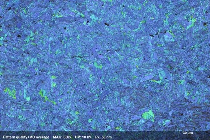 Bruker: Figure 1: Grain Average Misorientation map (false color) of bainitic steel, identifying regions with higher plastic deformation and dislocation density in green and yellow (>6° misorientation).